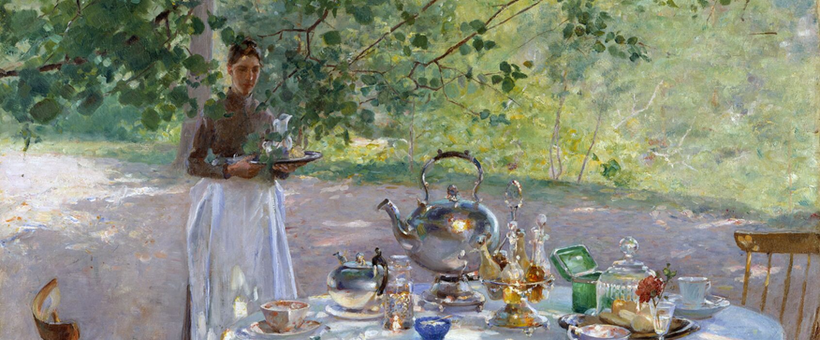 A table outside during summer time with a breakfast being served.