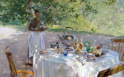 A table outside during summer time with a breakfast being served.