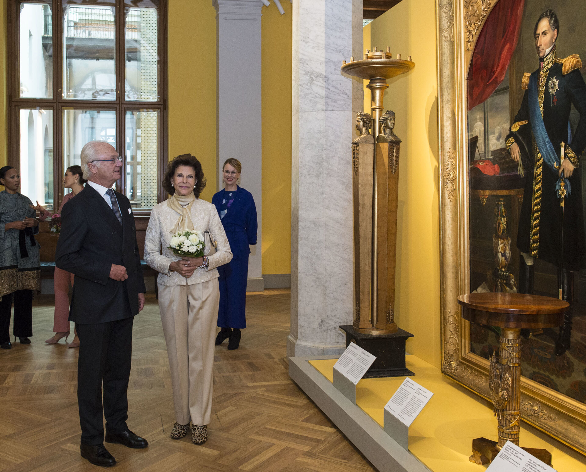 HM King Carl of Sweden, HM Queen Silvia looking at the portrait of King Karl XIV, painted by Emile Mascré.