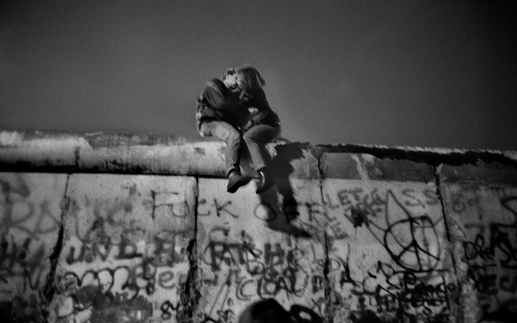 Guy Le Querrec, Germany. Berlin. On the wall, people celebrating New Year's Eve. Near the Brandenurg Gate, after the fall of the wall in November 1989. Sunday 31st December, 1989 (around midnight). ©Guy Le Querrec/Magnum Photos