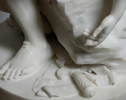 Detalj av skulptur, fot, hand och några verktyg som används vid skulptering.