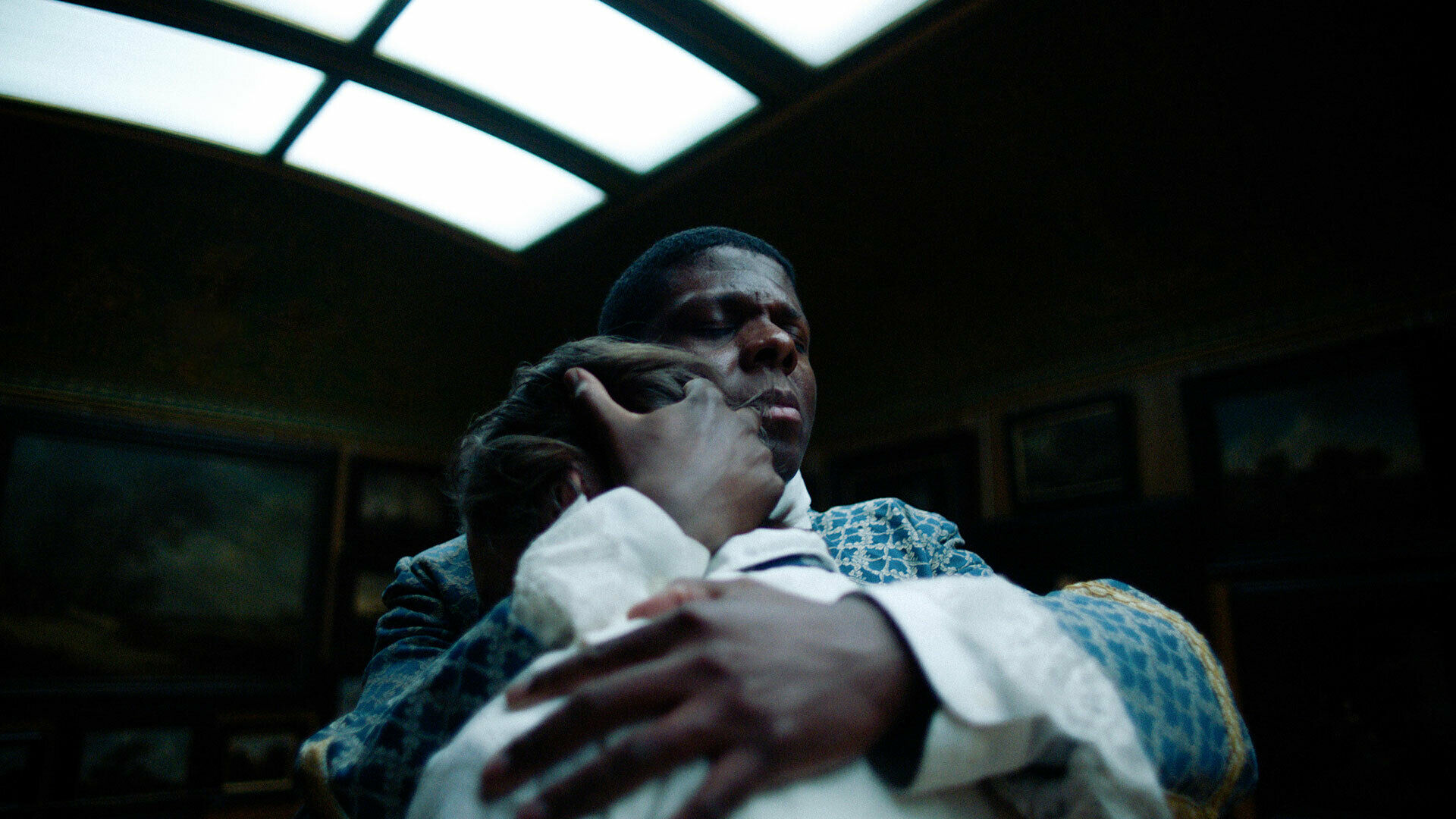 Foto från film, med en man i 1700-talskläder som står och håller om en annan man.